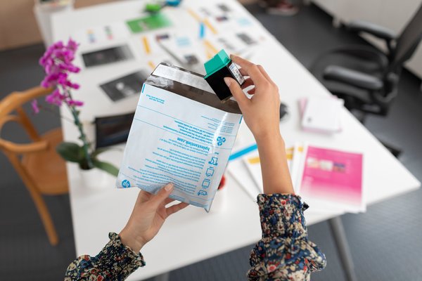 HP Ink Cartridge being recycled by a woman
